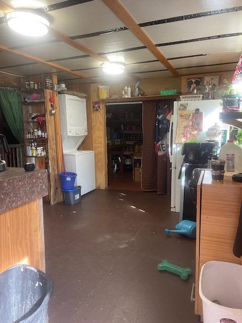 basement featuring stacked washer / dryer