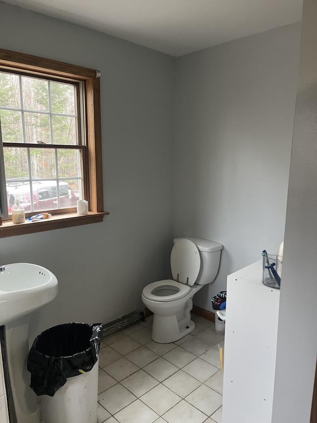 half bath featuring toilet and tile patterned flooring