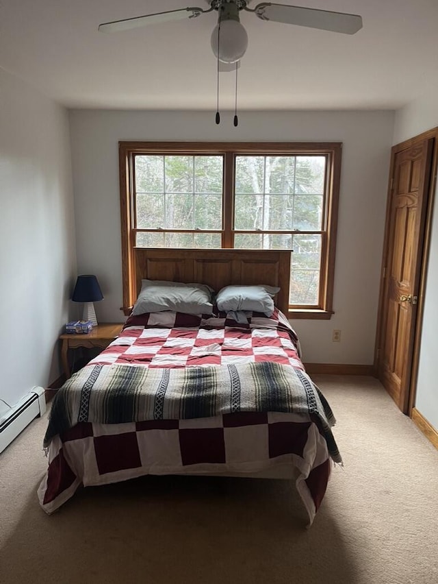 bedroom featuring a ceiling fan, carpet, and baseboards