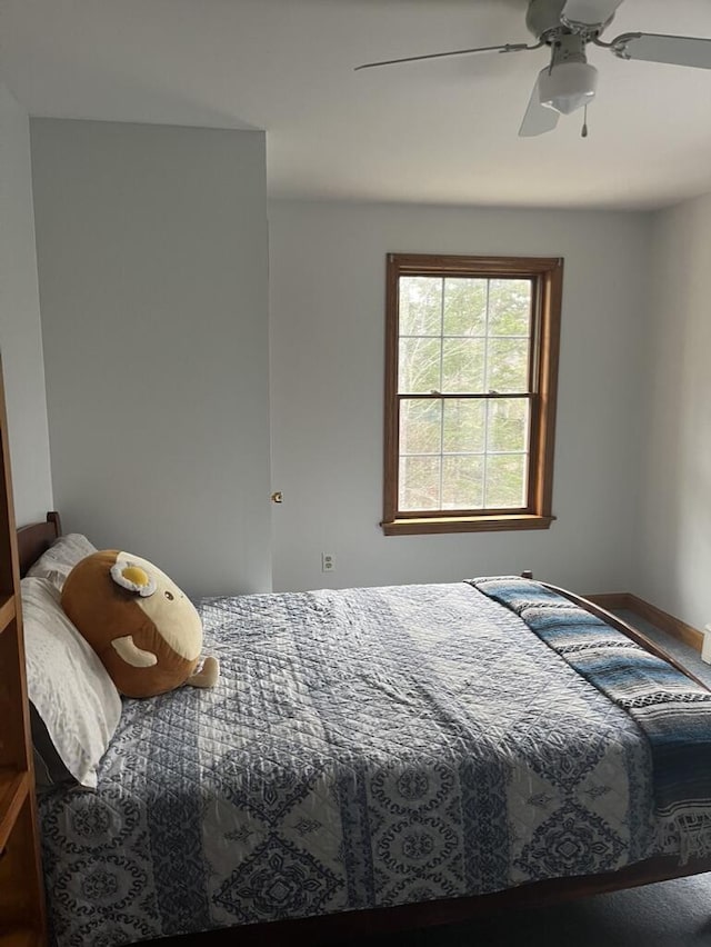 bedroom featuring baseboards and ceiling fan