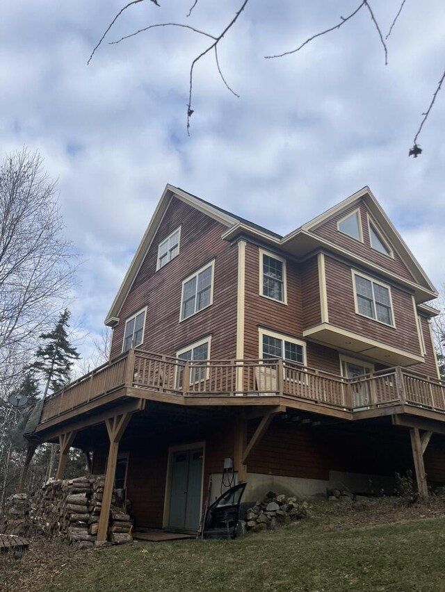 rear view of house featuring a wooden deck