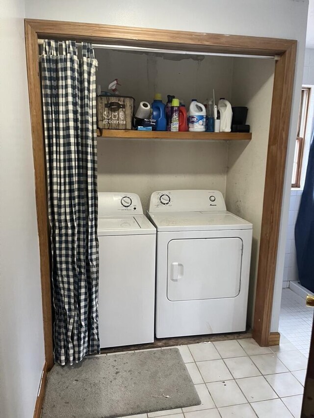 laundry area featuring independent washer and dryer and light tile patterned floors