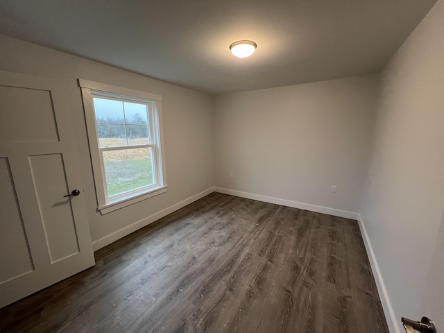 spare room featuring dark hardwood / wood-style flooring