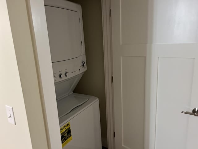 laundry area with stacked washer / dryer