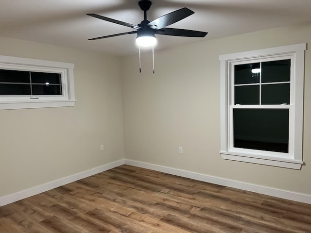 spare room featuring hardwood / wood-style floors and ceiling fan