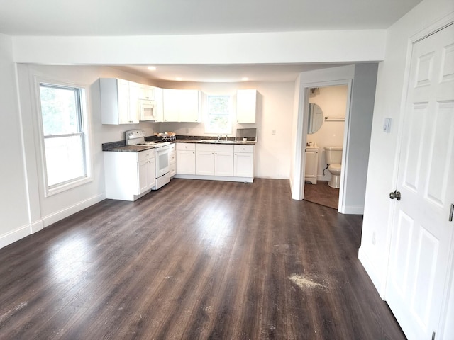 kitchen with dark hardwood / wood-style floors, white appliances, white cabinetry, and sink