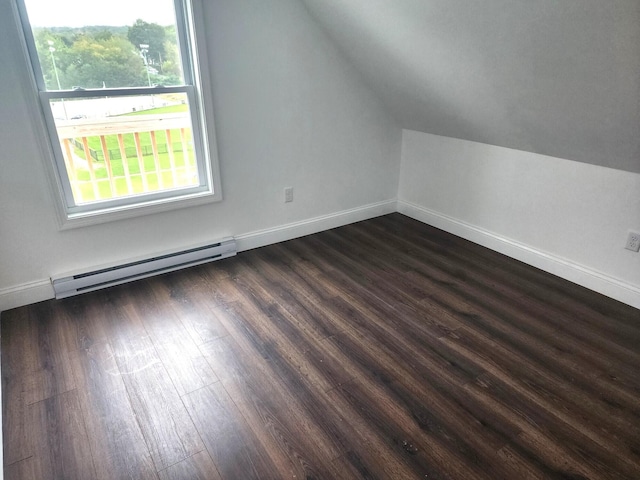 bonus room with vaulted ceiling, dark hardwood / wood-style flooring, and a baseboard heating unit