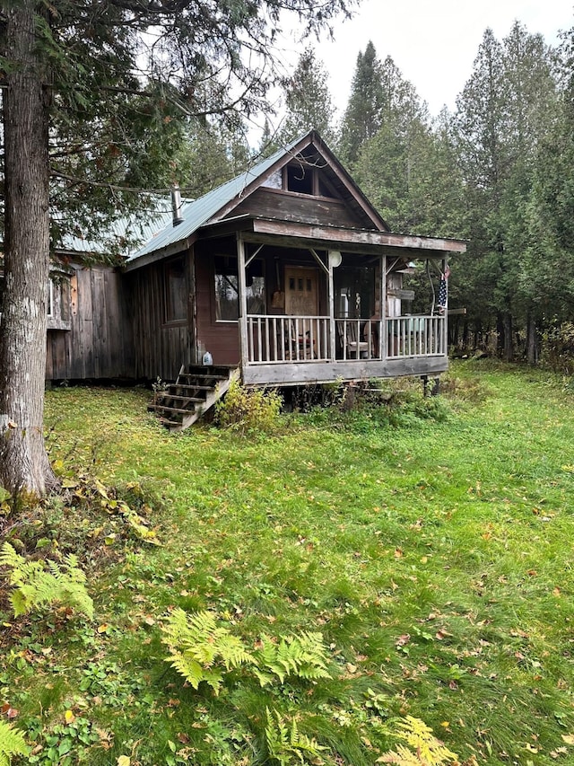 rear view of property with a yard