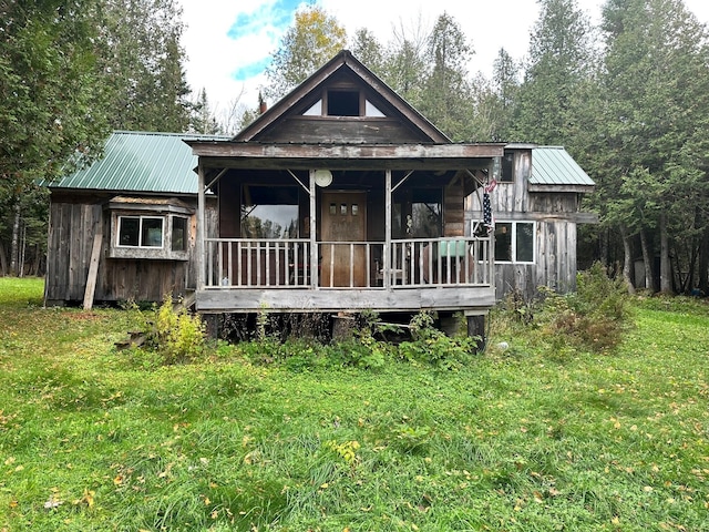 rear view of property with a yard