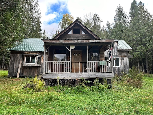 rear view of property featuring a yard