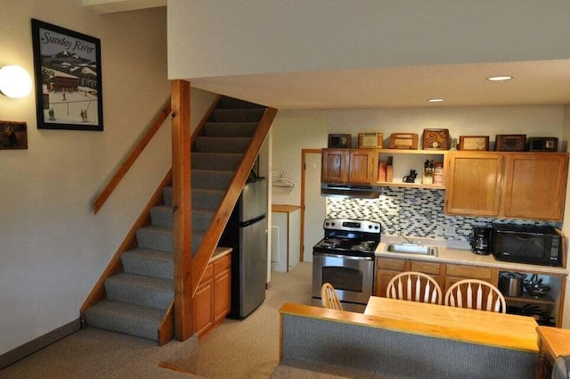 kitchen featuring light carpet, tasteful backsplash, sink, and stainless steel appliances