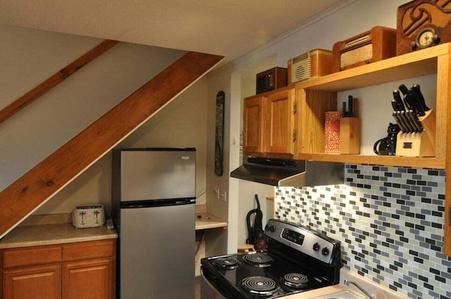 kitchen with range, backsplash, and stainless steel fridge