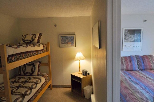 carpeted bedroom featuring a textured ceiling