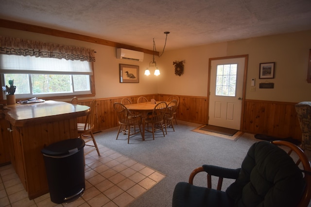 dining space featuring a wealth of natural light, light carpet, and a wall unit AC