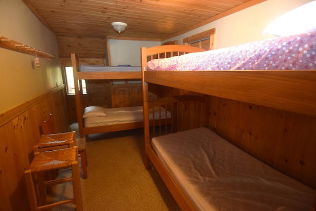 bedroom with wooden walls and wooden ceiling