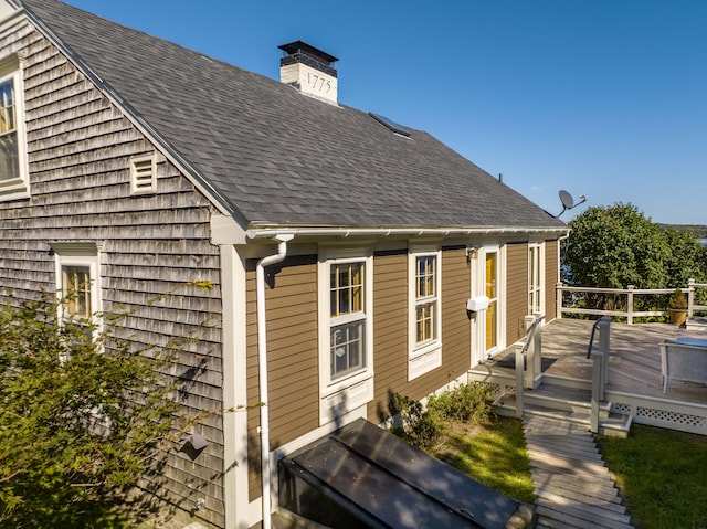 view of side of home featuring a wooden deck