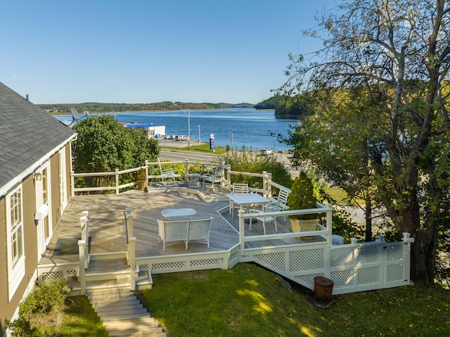 wooden deck featuring a yard and a water view