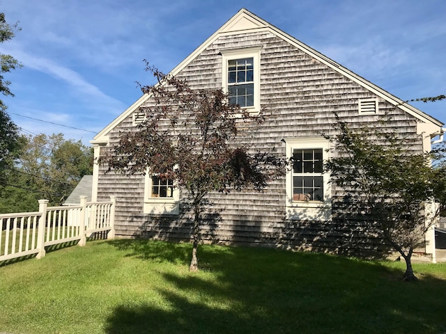 view of property exterior featuring a lawn