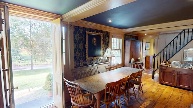 dining area featuring light hardwood / wood-style flooring and ornamental molding