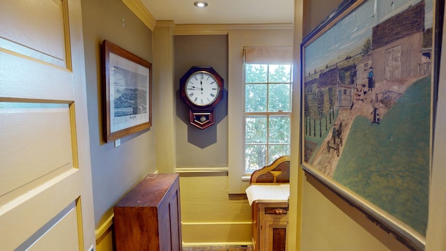 hallway featuring ornamental molding