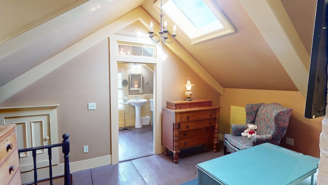 interior space featuring a chandelier, dark wood-type flooring, and vaulted ceiling with skylight