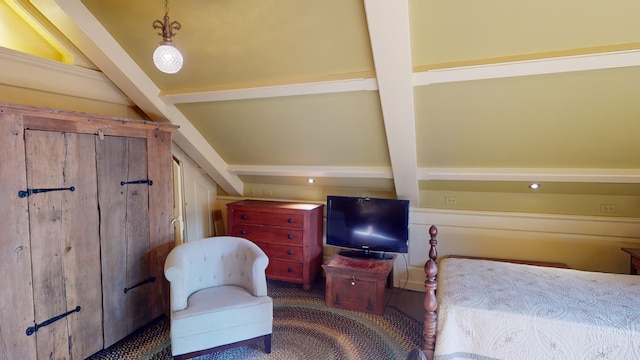 carpeted bedroom with beamed ceiling