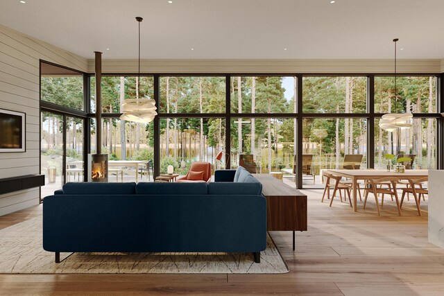 living room featuring a wall of windows, wood walls, and light wood-type flooring