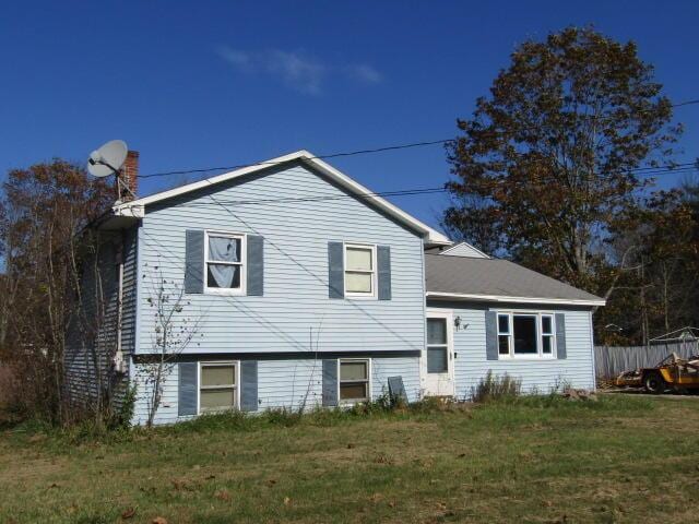 23 Dumas St, Lisbon, ME 04252 - split level home with a front lawn and a chimney