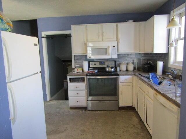 23 Dumas St, Lisbon, ME 04252 - kitchen featuring white appliances, backsplash, decorative light fixtures, and white cabinetry