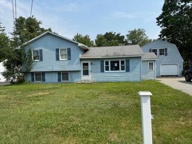 23 Dumas St, Lisbon, ME 04252 - view of front of home with a garage and a front yard