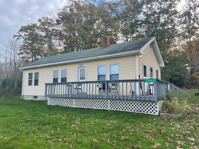 exterior space with a front lawn and a deck