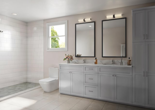 bathroom featuring tile patterned flooring, a tile shower, vanity, and toilet