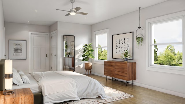 bedroom with ceiling fan and light wood-type flooring