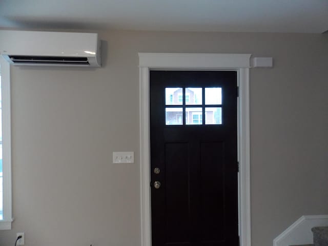 foyer entrance featuring a wall mounted air conditioner