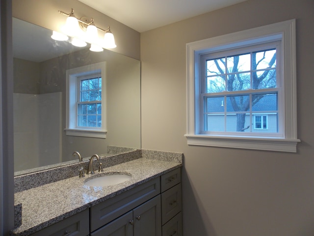 bathroom with large vanity and a wealth of natural light