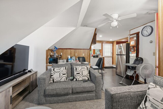 living room with wood walls and ceiling fan