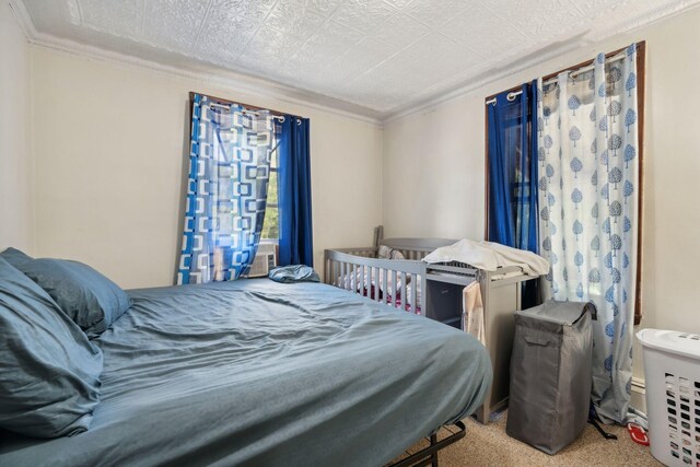 bedroom featuring crown molding and carpet flooring