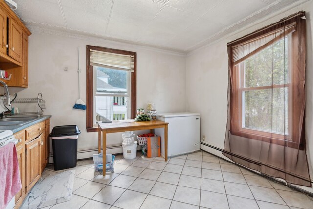 kitchen with a baseboard radiator, electric range, and light tile patterned floors