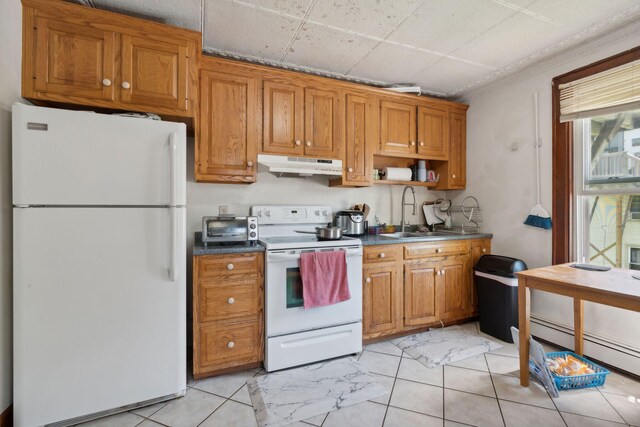 kitchen featuring a drop ceiling, light tile patterned flooring, white appliances, sink, and a baseboard heating unit