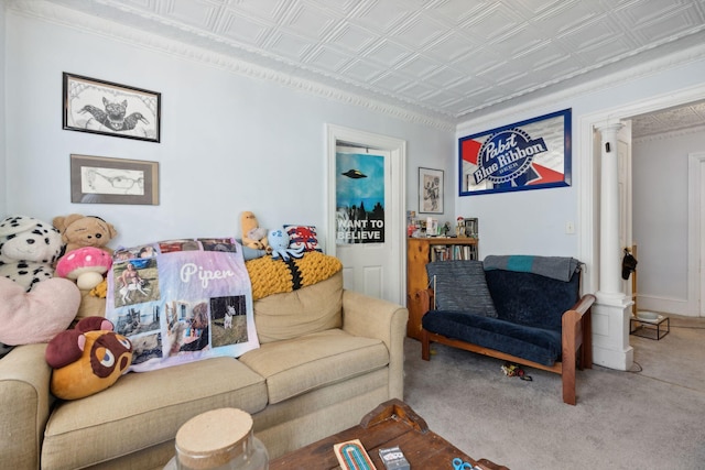 living room with decorative columns, crown molding, and carpet flooring