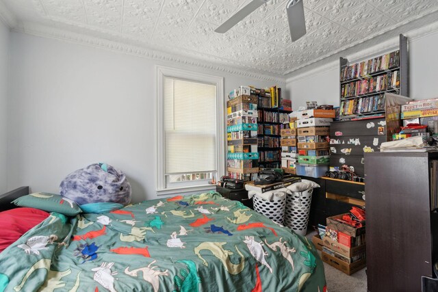 bedroom with ceiling fan, carpet flooring, and ornamental molding