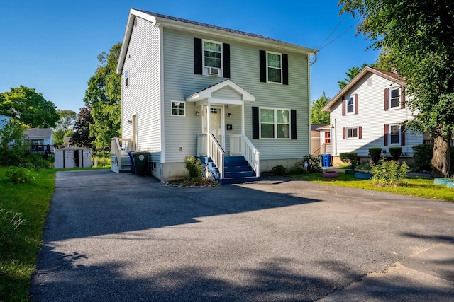 view of front facade with a storage shed