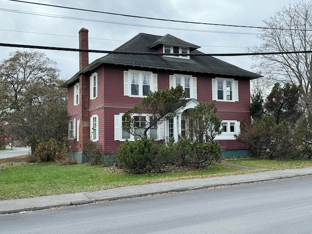 colonial-style house with a front yard