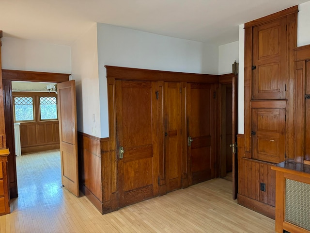 corridor with light hardwood / wood-style floors