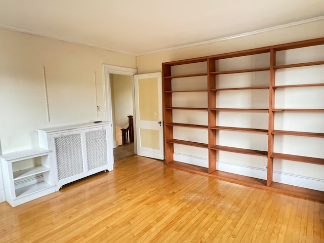 spare room with radiator and light hardwood / wood-style flooring