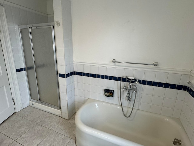 bathroom featuring tile flooring and independent shower and bath