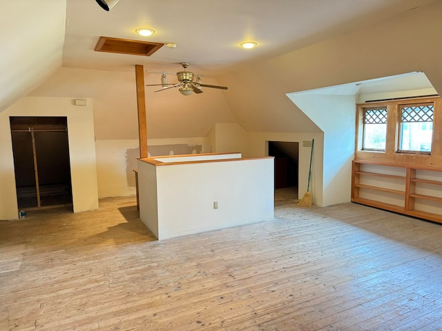 bonus room with lofted ceiling, light hardwood / wood-style floors, and ceiling fan