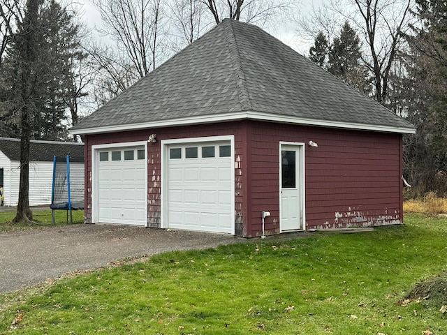 garage featuring a yard