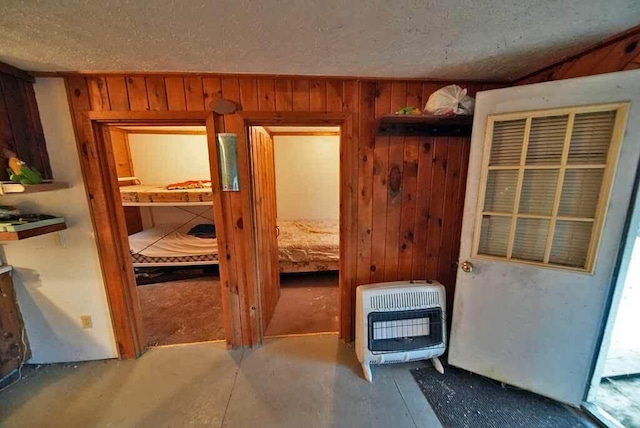 interior space with wood walls and a textured ceiling