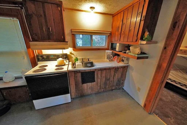 kitchen featuring a textured ceiling, white electric range oven, custom exhaust hood, and sink